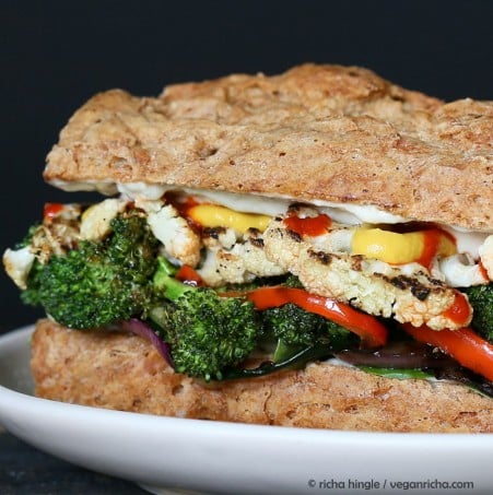vegetable sandwich  close-up side view of a roasted vegetable sandwich with sriracha mayo on a spelt almond flour bun