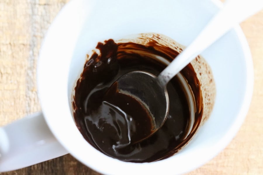 vegan milkshakes melted dark chocolate in a white cup with a spoon