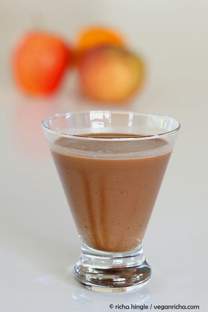 vegan milkshakes side view of a glass of vegan chocolate milkshake made with almond milk