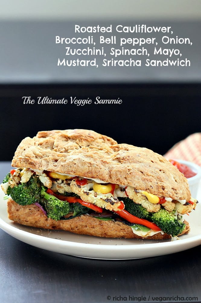 vegetable sandwich  side view of a vegan roasted vegetable sandwich made with grilled broccoli, cauliflower, bell pepper and sriracha mayo