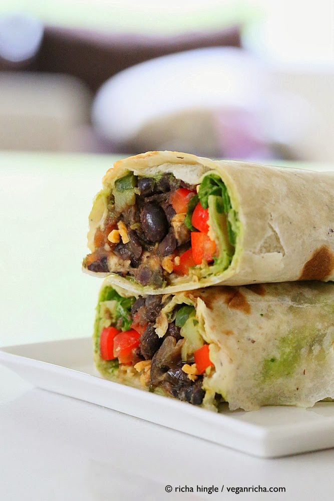 vegan wrap recipe side view of two stacked haves of Vegan Smoky Black Bean Wraps with Parsley Chimichurri