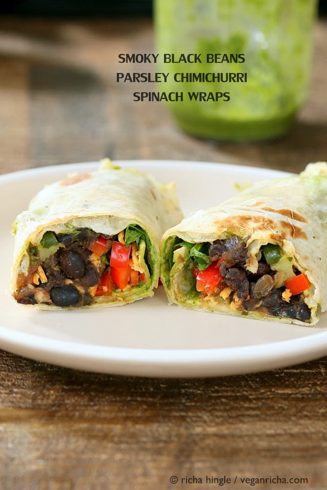 vegan wrap recipe  side view of two halves of a vegan wrap with black beans, bell pepper and vegan cheese on a white plate