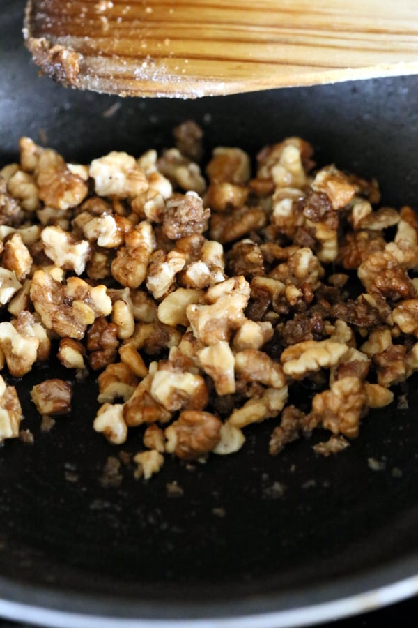 vegan ice cream recipe walnuts being candied in a frying pan with raw sugar