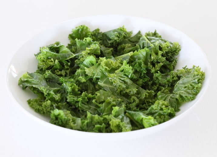 kale salad recipe  massaged kale in a small white bowl