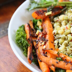 side view of kale salad with mung beans and seared carrots