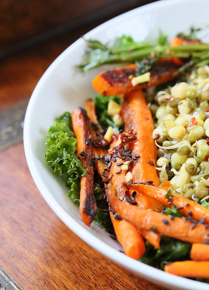kale salad recipe close-up of pan seared carrots and mung beans on a bed of kale