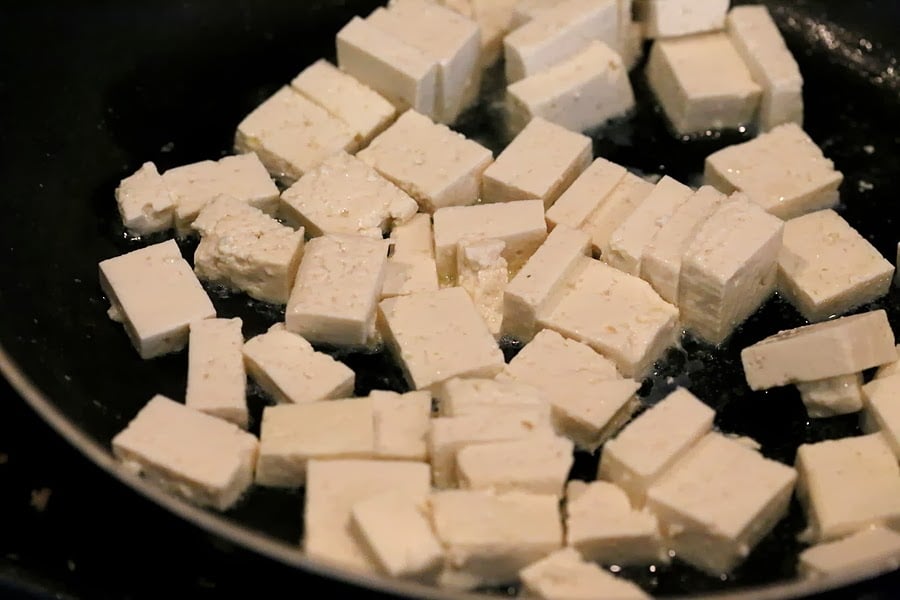 Tofu getting panfried in a skillet for our Vegan Palak tofu Paneer