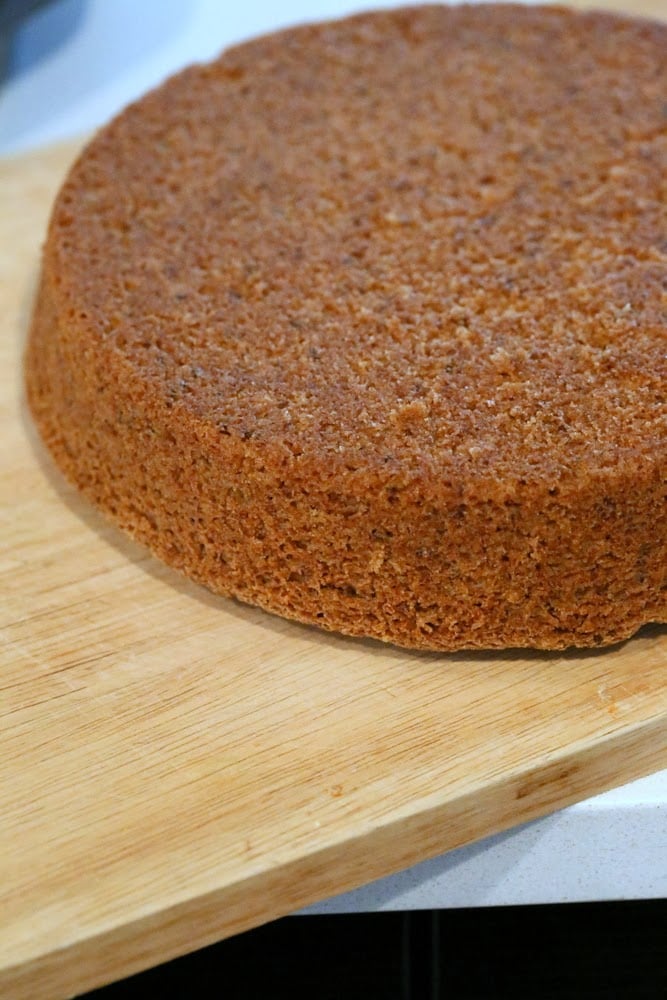 mousse cake a vegan vanilla sponge cake being transferred to a wooden board