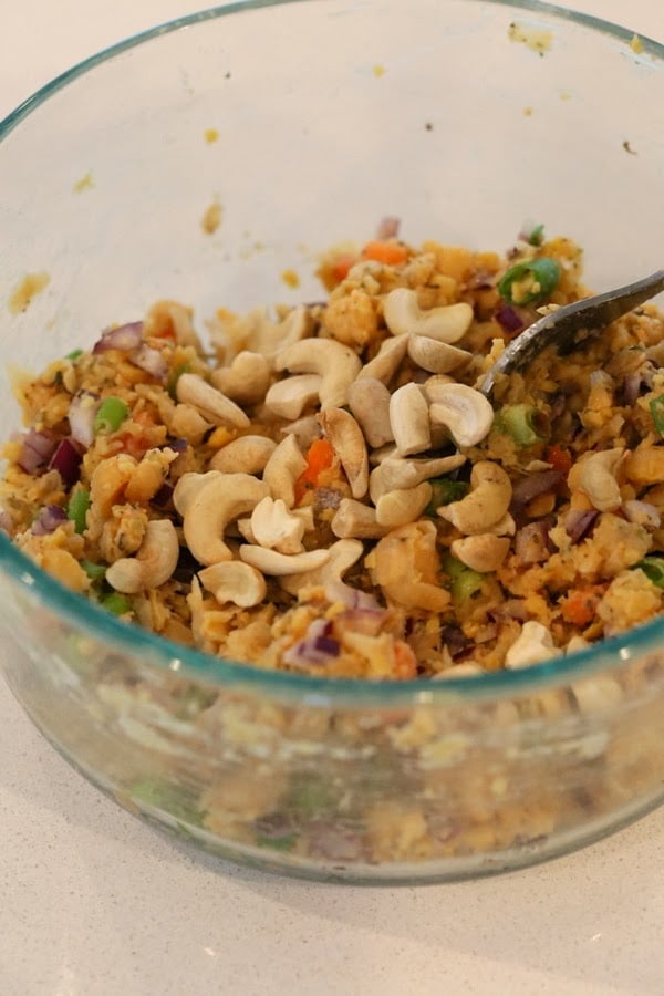 stuffed portobello mushrooms  cashews being added to vegan filling for making stuffed portobello mushrooms recipe
