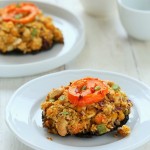 side view of vegan stuffed Portobello Mushrooms on a white plate