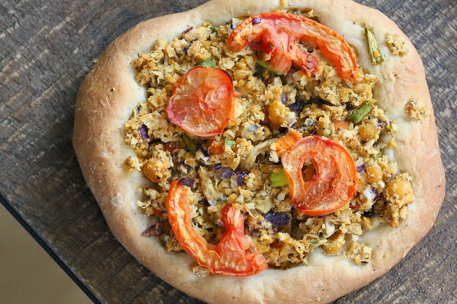 overhead shot of a vegan pizza with chickpea topping
