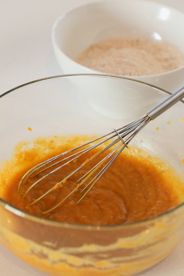 recipe for vegan donuts  wet ingredients for vegan sweet potato donuts being whisked in a glass bowl
