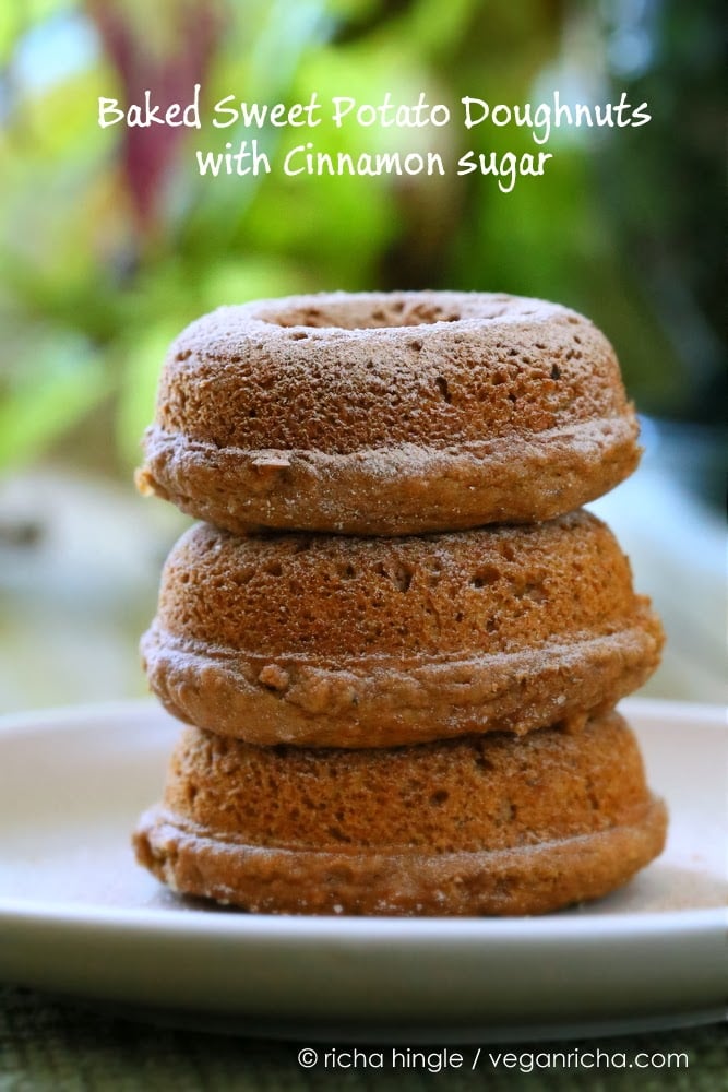 recipe for vegan donuts  three sugar-dusted Baked Vegan Sweet Potato Doughnuts stacked on a white plate