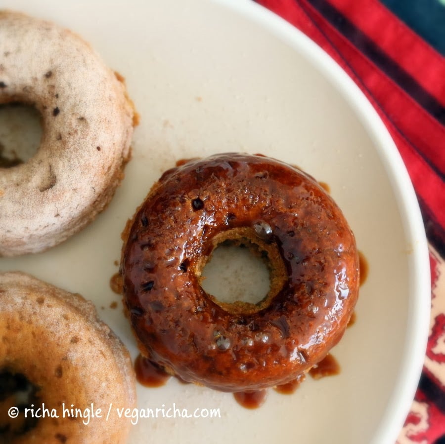 recipe for vegan donuts overhead shot of Baked Vegan Sweet Potato donuts glazed with salted caramel on a white plate