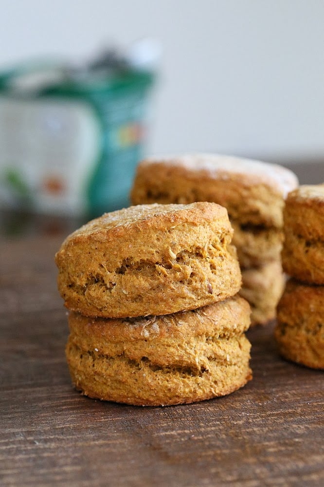 sweet potato biscuits  side view of stacked healthy vegan sweet potato biscuits on a wooden board