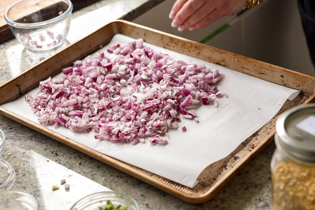 spreading onion onto the baking sheet