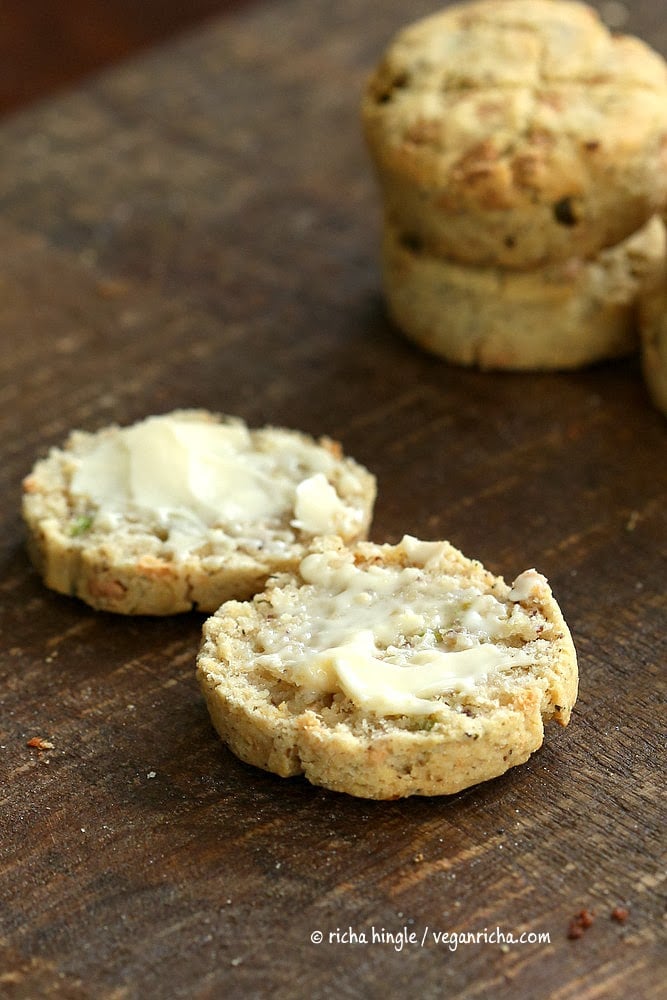 gluten free biscuits recipe a halved vegan and gluten-free biscuit served on a wooden board with a smear of butter