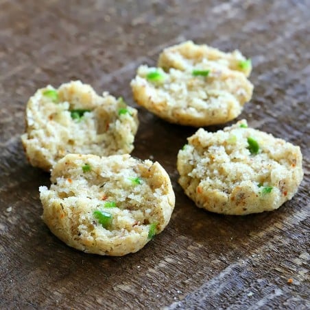 recipe for gluten free biscuits  two small gluten-free cheese biscuits cut into halves to reveal specks of jalapeno pepper