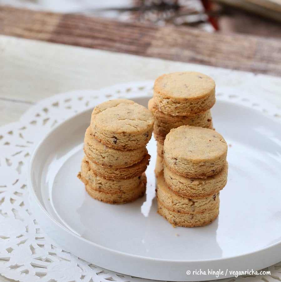 vegan sugar cookies  vegan sugar cookies stacked on a white cookie platter