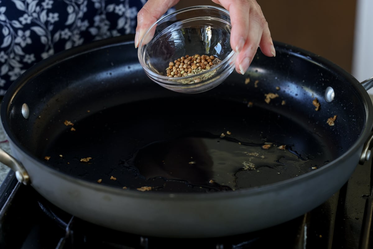 adding whole spices to the pan