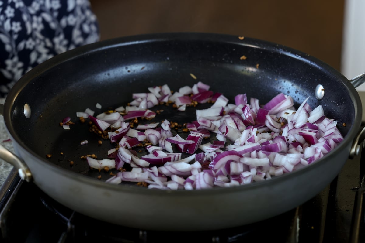 adding onion to the pan