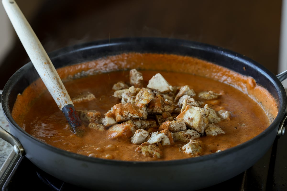 adding tofu to the pan of cooked Pasanda sauce