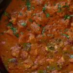 close-up of tofu Pasanda in the pan with cilantro garnish
