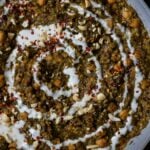 chickpea lentil spinach stew in the pan topped with garnishes