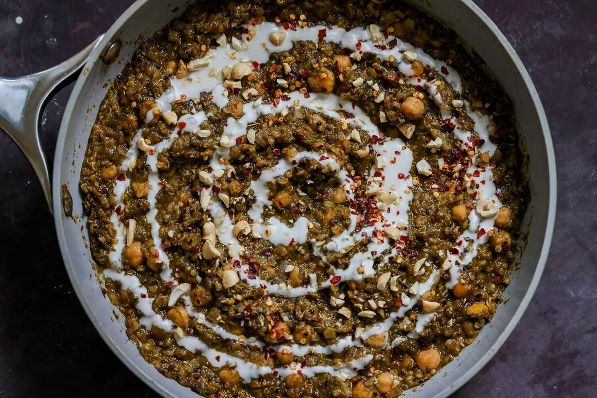 chickpea lentil spinach stew in the pan topped with garnishes