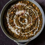 chickpea lentil spinach stew in the pan topped with garnishes