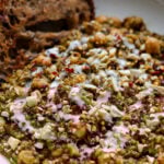 chickpea lentil spinach stew in a bowl with bread to dip