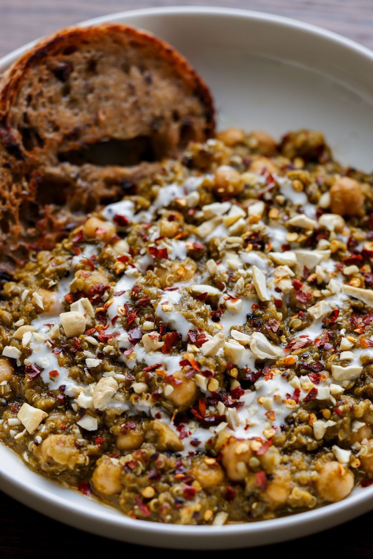 chickpea lentil spinach stew in a bowl with bread to dip