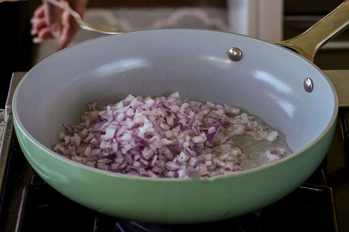 adding onions to the pan