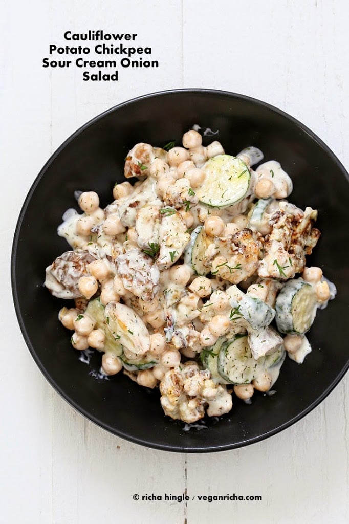 Vegan potato salad with chickpeas and cauliflower in a black bowl