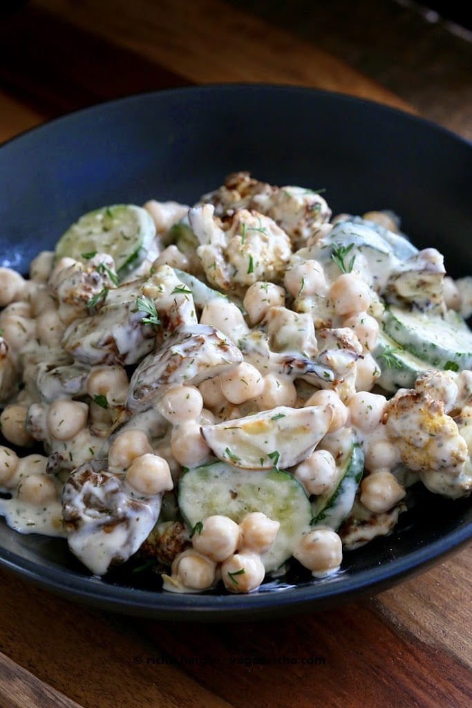 Vegan potato salad with chickpeas and cauliflower in a black bowl