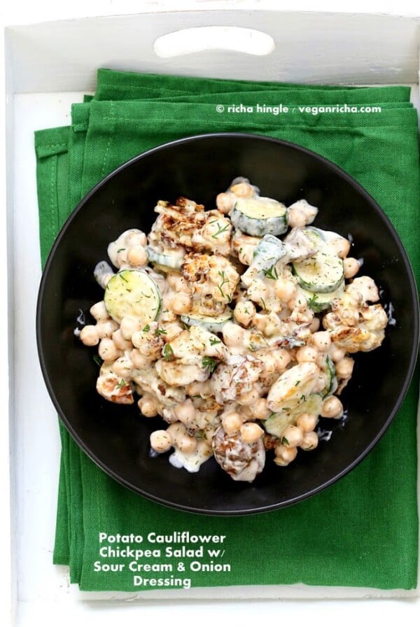 Vegan potato salad in a black bowl on a green kitchen towel
