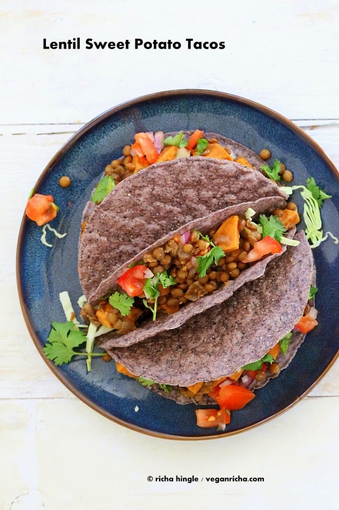 Smoky lentil and sweet potato tacos on a blue plate