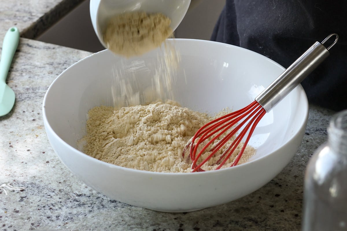 adding dry ingredients to the bowl