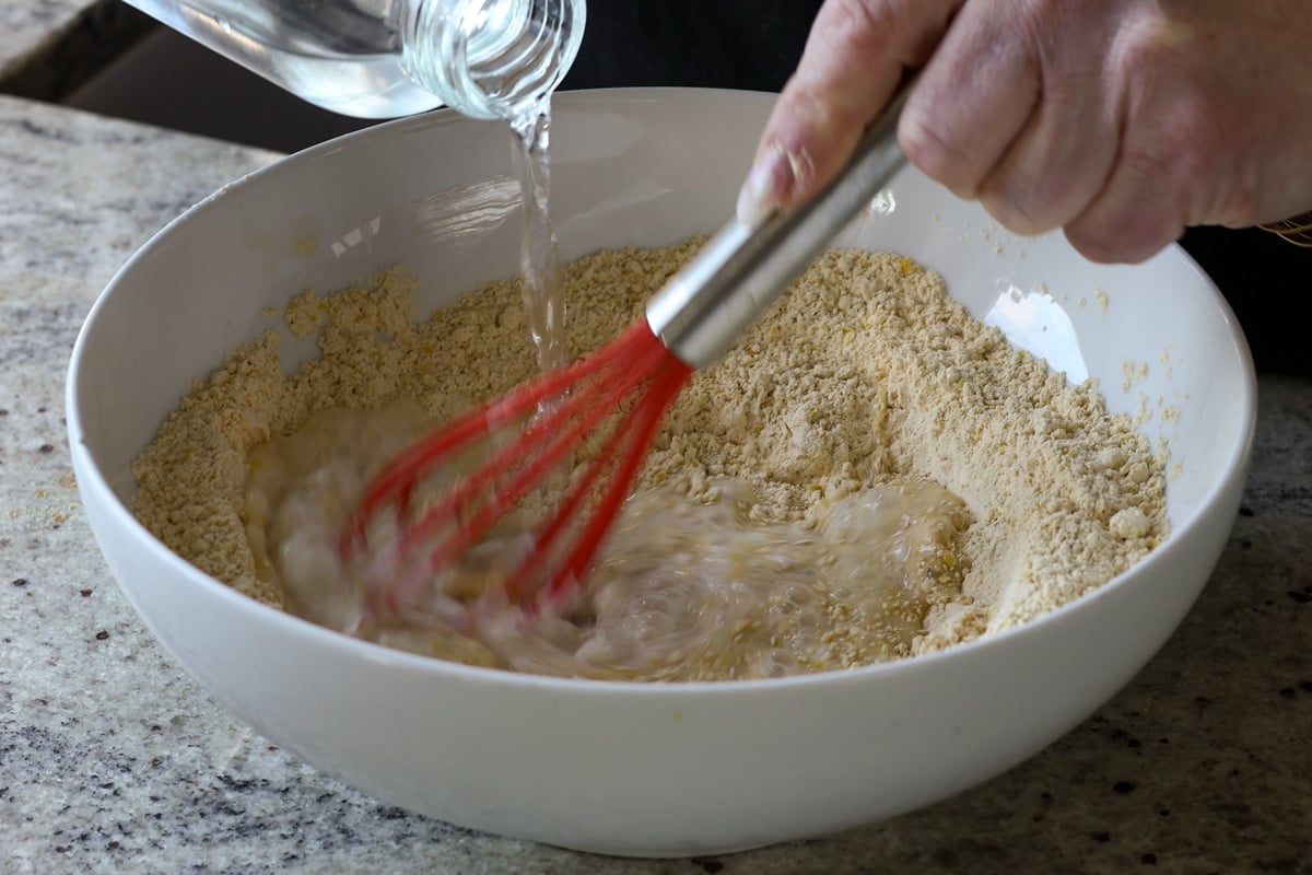 adding water to the dry ingredients