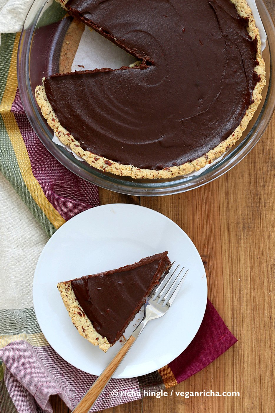 vegan pumpkin pie  overhead shot of a Vegan Chocolate Pumpkin Pie in a pyrex pie dish with plated slice of pie on the side