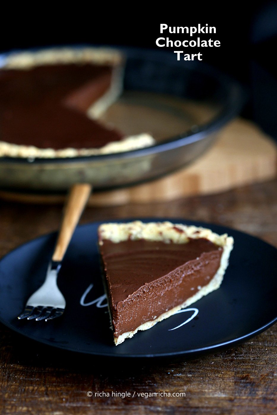 vegan chocolate pumpkin pie  a slice of Vegan Chocolate Pumpkin Pie on a black plate with a fork on the side