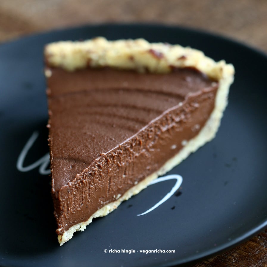 Vegan Pumpkin Pie  close-up of a slice of Vegan Chocolate Pumpkin Pie with Almond Flour Pie Crust on a black plate