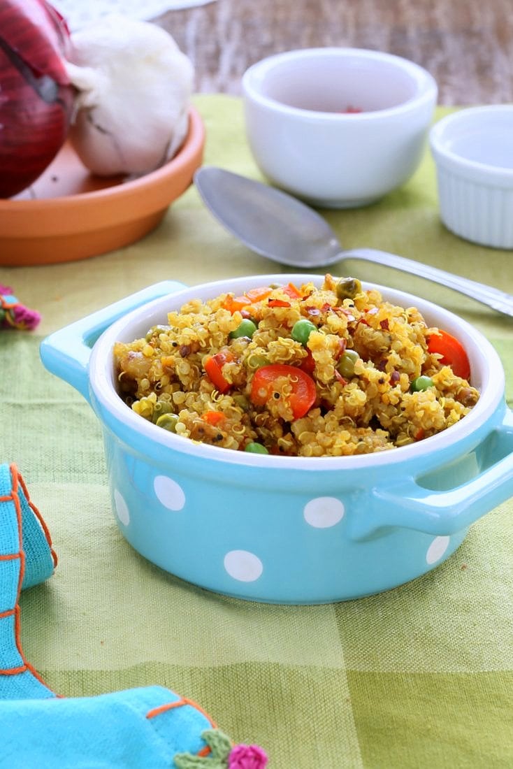 South Indian Quinoa Salad in a blue polka dot dish with spoon
