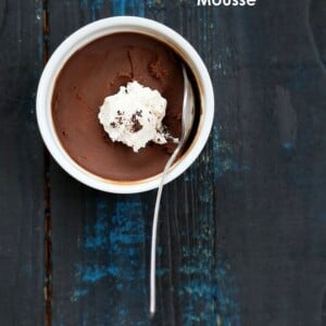 Vegan Chocolate Mousse in a white ramekin with coconut whipped cream and a spoon