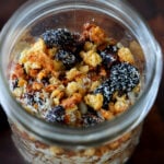 top-down photo of red lentil granola in a mason jar