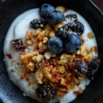 close-up of a bowl of yogurt topped with red lentil granola