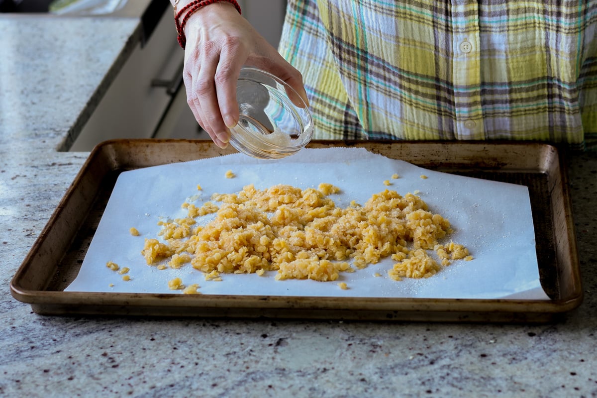 adding red lentils to the baking pan