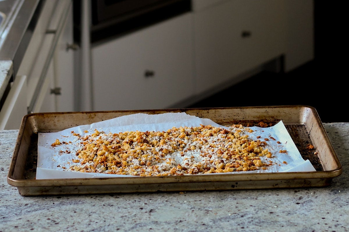 red lentil granola spread out on the baking pan, after baking