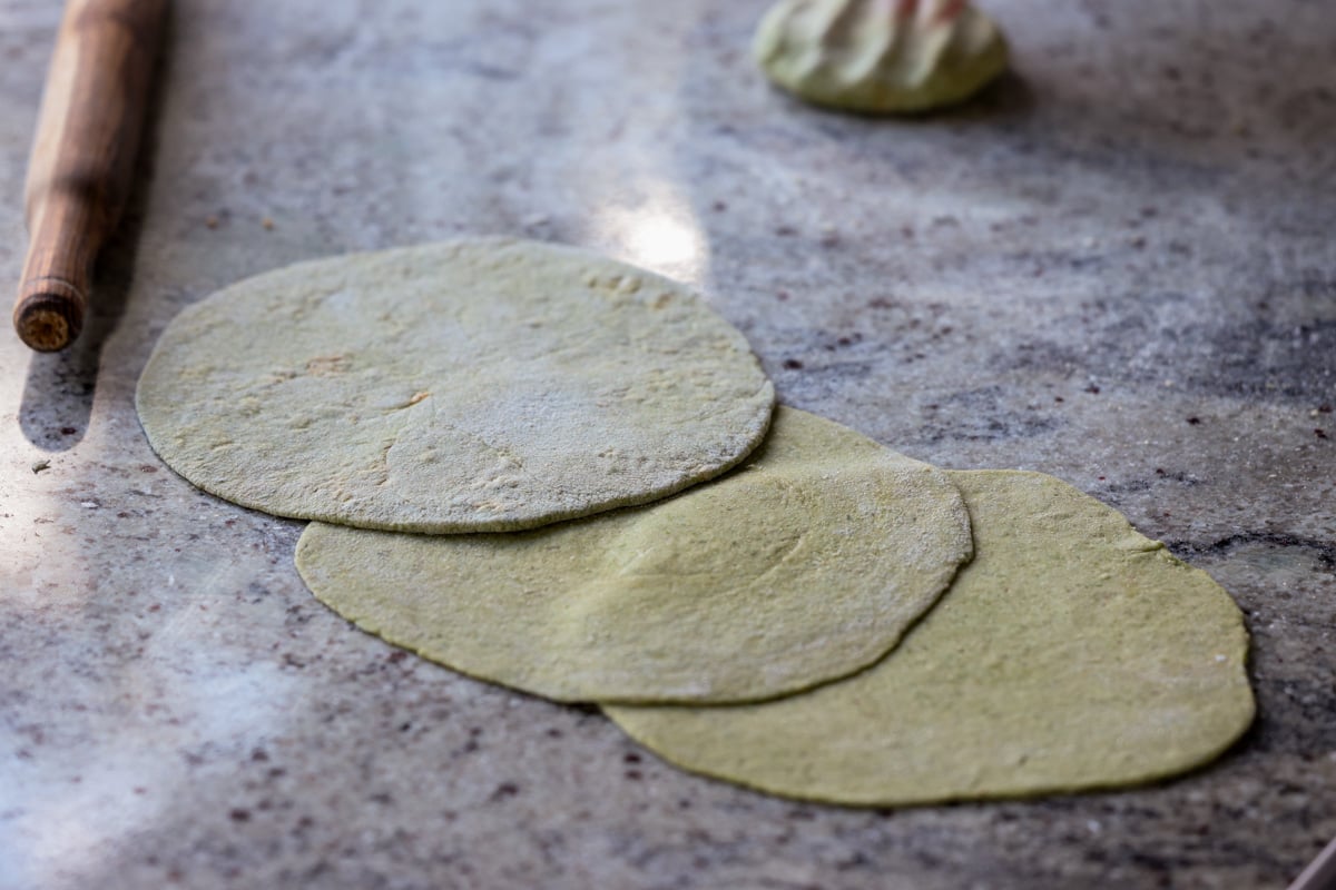 spinach paratha rolled out on the counter