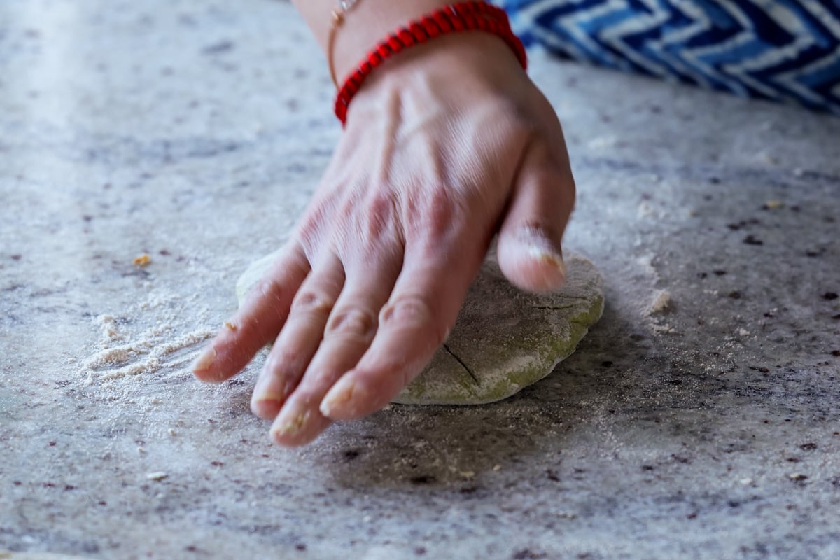 flattening the stuffed paratha